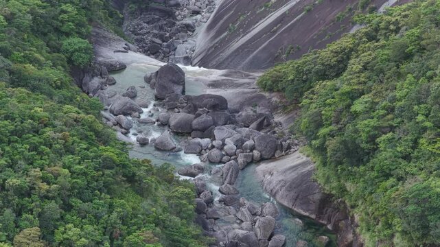 Flying over towering waterfall in rock canyon - Senpiro Falls - Yakushima, Japan