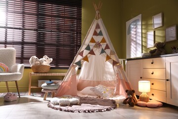 Beautiful wigwam, cushions and toys in child's room © New Africa