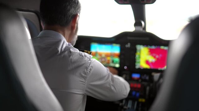Experienced male pilot preparing for takeoff in airplane cockpit