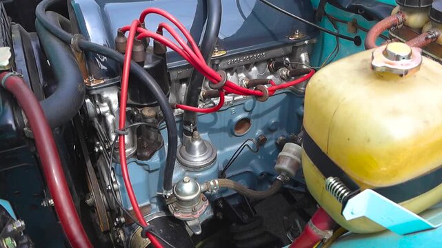 Close up view of a perfectly restored and running engine from a classic eastern european automobile, showcasing the pistons' movement and the pristine condition of its various components