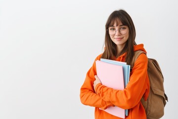 Naklejka premium The student in orange hoodie holding colorful notebooks and backpack smiling confidently