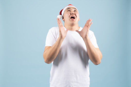 Young man clasping hands together begging or asking for favor