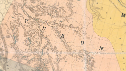 Fototapeta premium Macro View of Vintage Map Highlighting Yukon Canada with Detailed Geographic Cartography