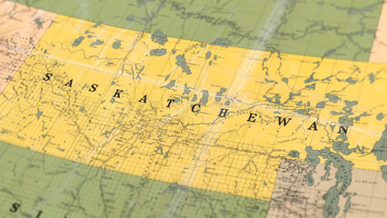 Fototapeta premium Macro View of Vintage Map Highlighting Saskatchewan Canada with Detailed Geographic Cartography
