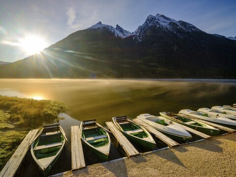 Rowing boats at Hintersee with morning fog at sunrise, in the back Hochkalter, Berchtesgaden National Park, Ramsau, Upper Bavaria, Bavaria, Germany
