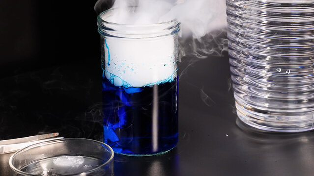 Dry Ice Sublimating in Blue Liquid Inside a Glass Jar
