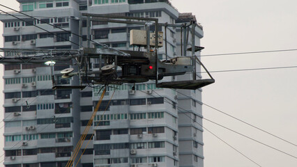 Industrial Cable Maintenance Rig Suspended Near High Rise Apartment Building © blueringmedia
