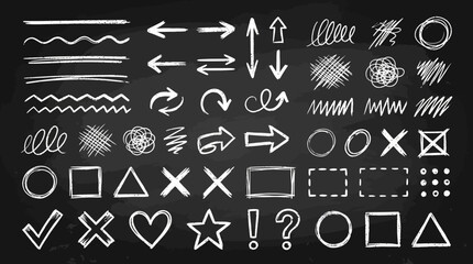 A collection of white chalk symbols and arrows drawn on a blackboard background © PYARA
