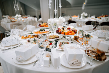Fototapeta premium Elegant banquet hall table set for a celebration reception with diverse appetizers