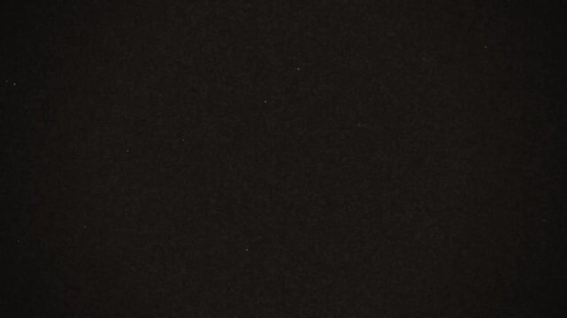 A close up view of a smooth black fabric texture with a soft matte finish showing fine woven details and a dark aesthetic pattern suitable for background design