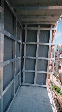 Facade support frame installation on residential building balcony