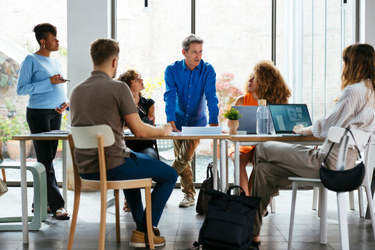 Business colleagues discussing strategy at desk in office