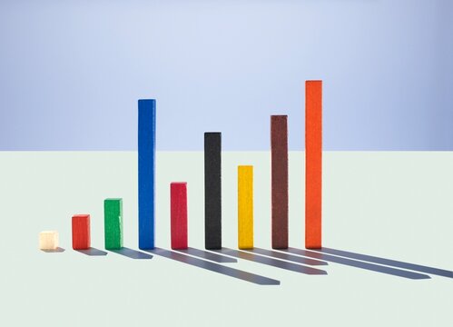 Multi colored wooden rods as a bar chart showing growth