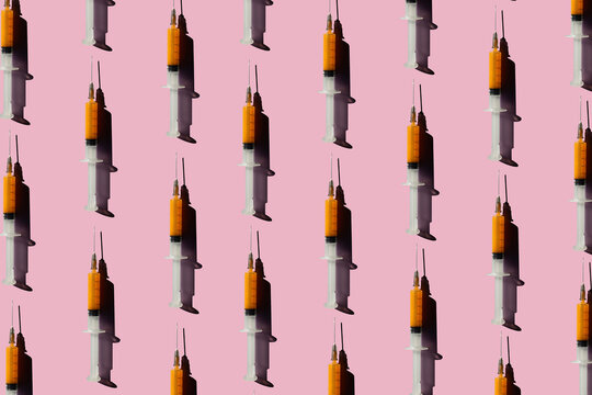 3D Illustration of syringes, pink background