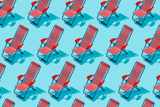 Repeated striped beach chair pattern on blue background