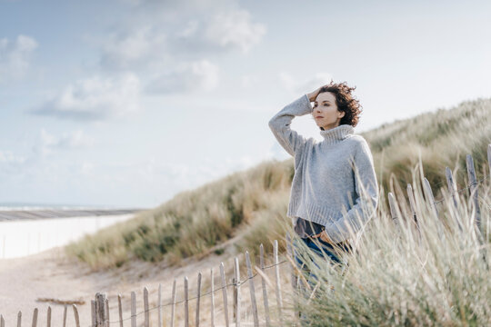 Woman standing in beach dune