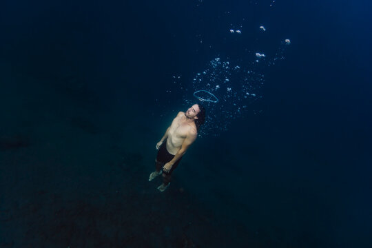Young man diving underwater