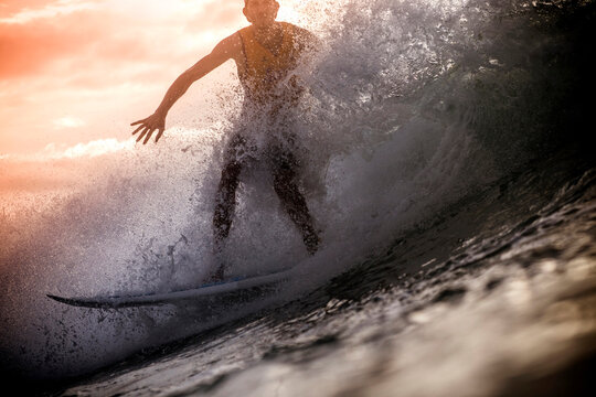 Indonesia, Lombok Island, surfing man at backlight