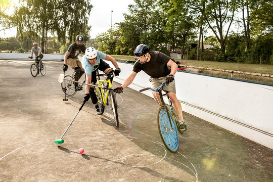 Germany, Hannover, Group of men playing bike polo