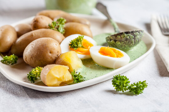 Plate of potatoes with boiled eggs, parsley and salsa verde sauce