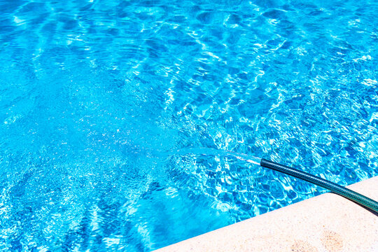 Swimming pool being filled by hose