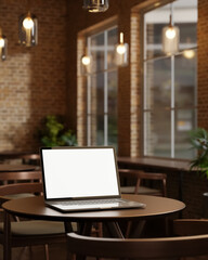 Fototapeta premium White screen laptop on round wooden table under glass lamp in bricks wall room at cafe or restaurant