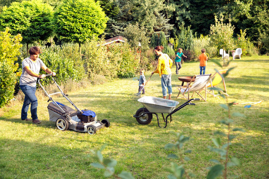Father mowing the lawn in garden