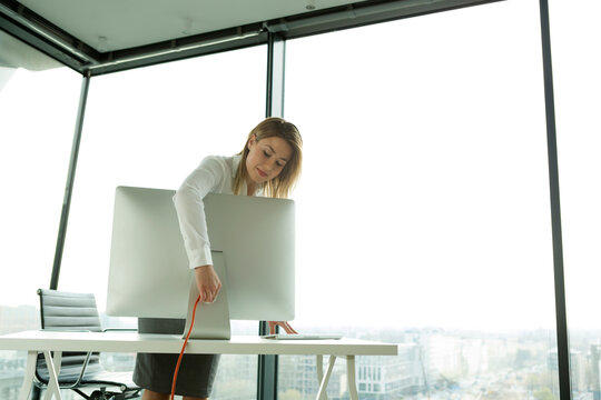 Businesswoman connecting computer monitor