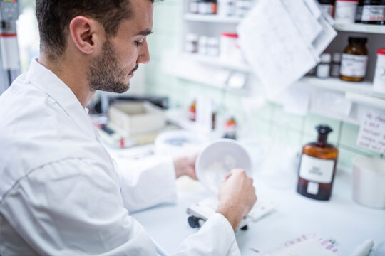 Man preparing medicine in laboratory of a pharmacy