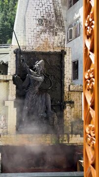 mystical shiva idol with trishul amid hot steam temple backdrop and spiritual ambiance at manikaran