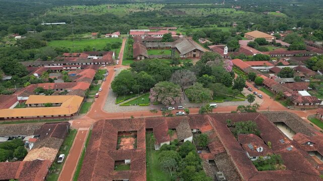 Aerial pulls out from central plaza, buildings in Concepcion, Bolivia