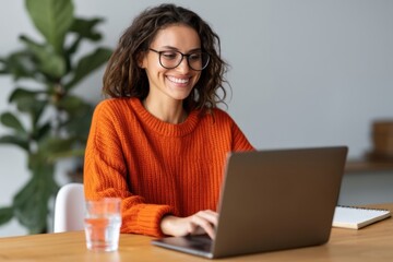 Fototapeta premium The woman at the laptop smiling while working from home in a cozy modern office