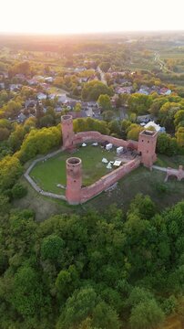 Aerial flyover of castle ruins in Poland at sunset in spring