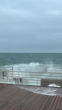 Powerful Storm Waves Crashing Against Wooden Boardwalk In Odessa
