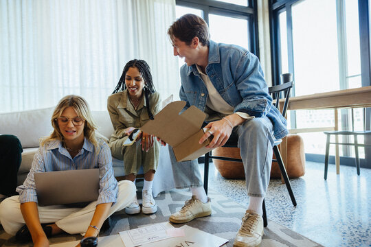 Young professionals collaborating on creative projects in a modern office environment