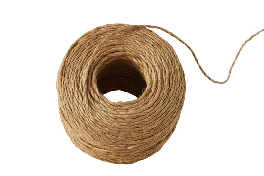 A round spool of natural brown twine string coiled in a circle isolated on a solid black background, for craft and, packaging projects