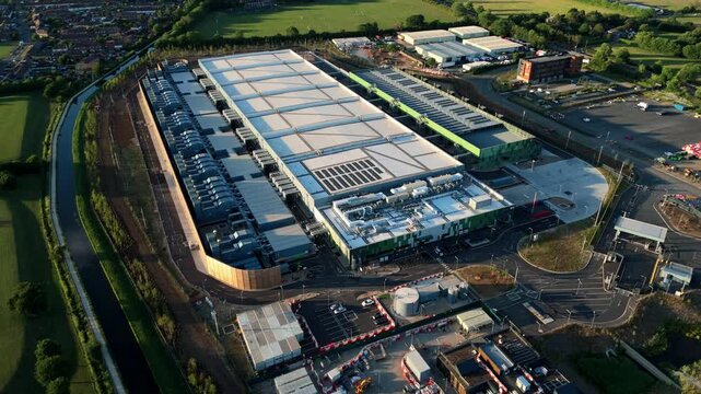 High-angle drone perspective looking down at the massive external cooling infrastructure of a modern technology data centre near London