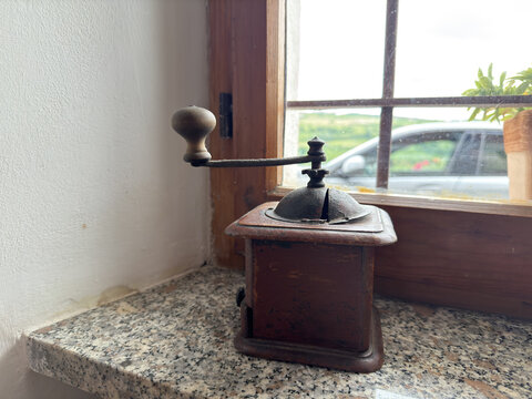 Vintage Wooden Coffee Grinder on a Granite Window Sill