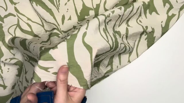 The patterned viscose and nylon fabric features a delicate bohemian design on a lightweight material with a distinct crinkled texture that creates soft drapes and flowing silhouettes