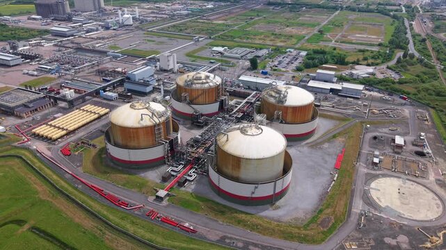 High aerial view of Isle of Grain LNG and LPG storage terminals with cryogenic silos and pipework manifolds, UK