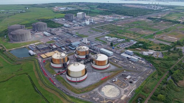 High aerial view of Isle of Grain LNG and LPG storage terminals with cryogenic silos and pipework manifolds, UK
