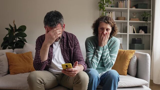 Mature receiving bad news on smartphone