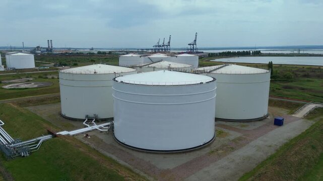 Close Up Aerial View of White LNG Storage Silos at a Major Energy Import and Export Terminal on the Isle of Grain UK