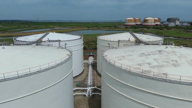 Close Up Aerial View of White LNG Storage Silos at a Major Energy Import and Export Terminal on the Isle of Grain UK