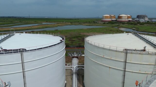 Close Up Aerial View of Energy Infrastructure Showing Heavy Duty Fuel Storage Tanks and Interconnecting Pipes UK