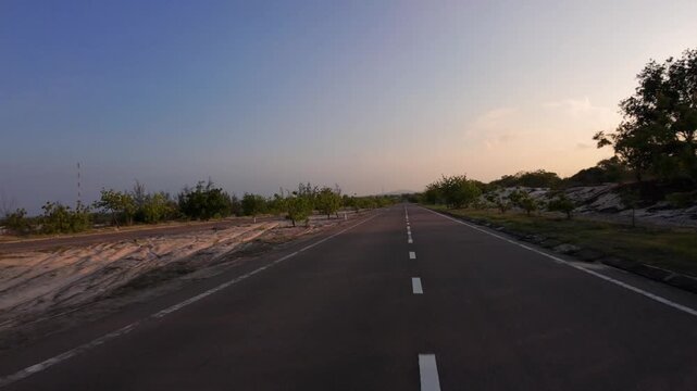 POV moving through beautiful white sand dunes desert road in Bau Trang Mui Ne at sunset