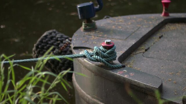 Boat tied with a rope on moorings