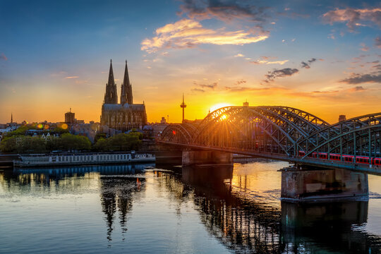 Elevated, calm summer sunset view of the cityscape of Cologne, Germany, with River Rhine, Hohenzollern Bridge and iconic Cathedral