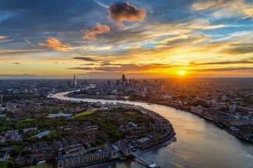 Wide panoramic sunset view of the London skyline in England with Thames River leading with its curved stream into the City © moofushi