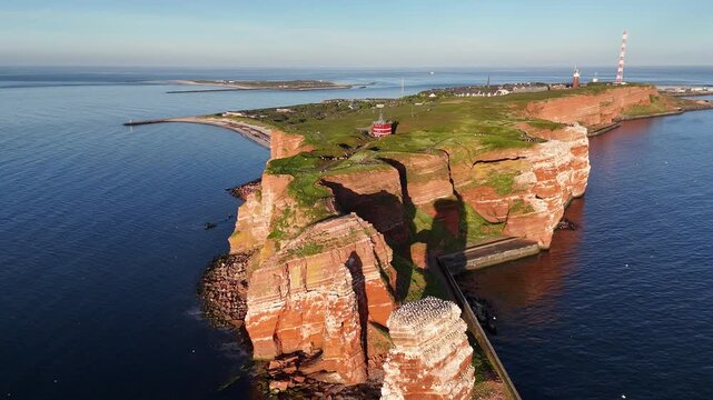 Evening aerial view of Lange Anna red cliffs seabird nesting sites and Helgoland coast.